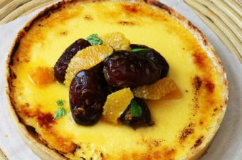 Custard Tart with citrus and dates on a platter