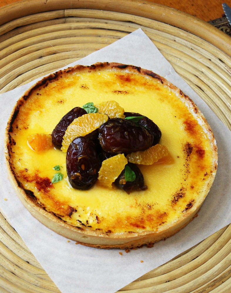 Custard Tart with citrus and dates on a platter
