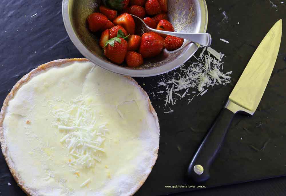 White chocolate strawberry tart with a bowl of dressed berries