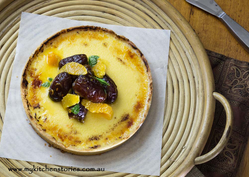 Custrad Tart with citrus and dates on a can plate