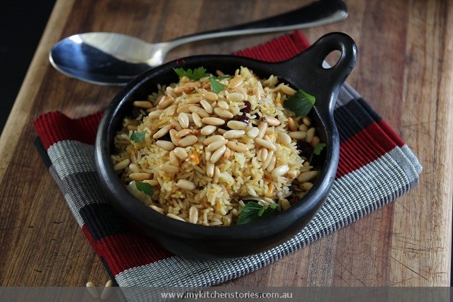 a black bowl filled with saffron rice