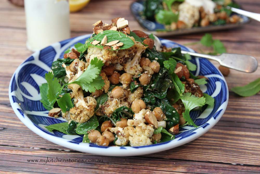a moroccan dish with Spice Roasted Cauliflower, Chickpea salad with herbs and almonds