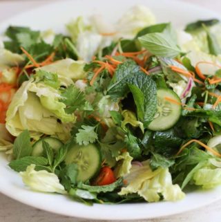 Vietnamese salad with cucumber and pickled carrot on a white platter