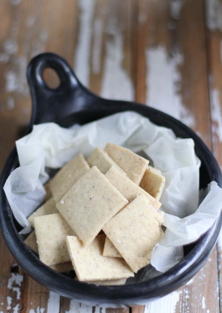Handmade crackers in a black pot wrapped in paper