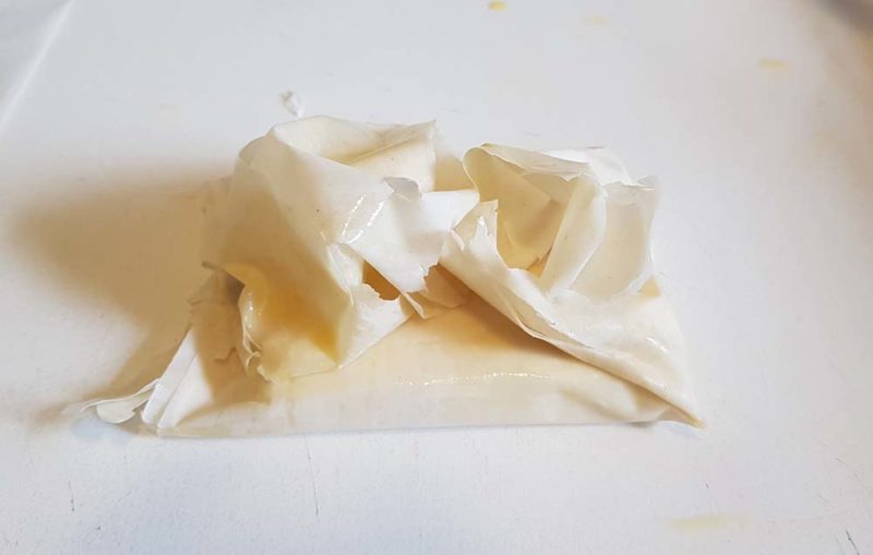 Uncooked filo parcel ready to be painted with butter
