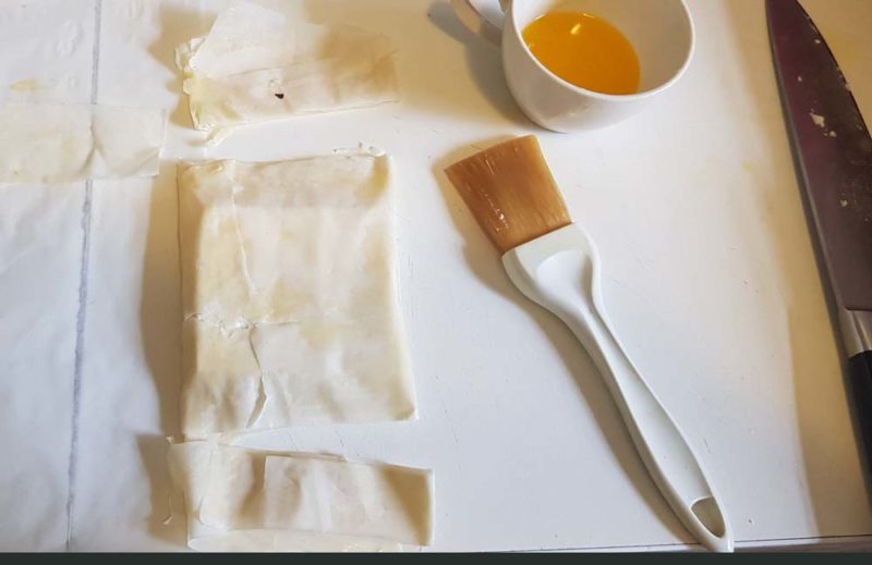 Wrapping and cutting the filo around feta cheese