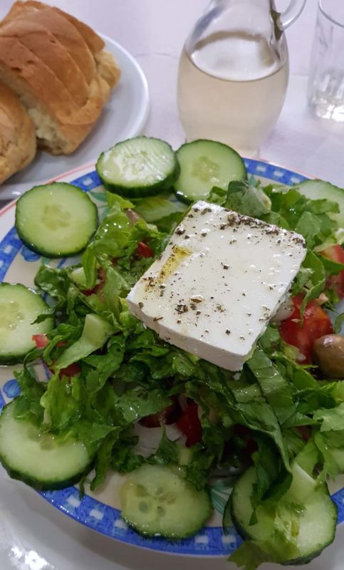 Rustic greek salad on a flat white plate