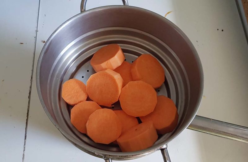 Steaming sweet potatoes in a pot