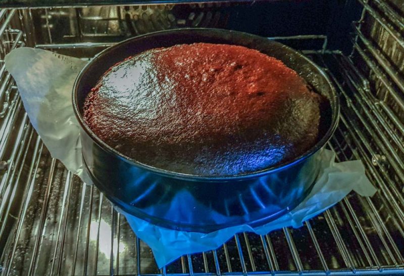 A chocolate cake baking in the oven
