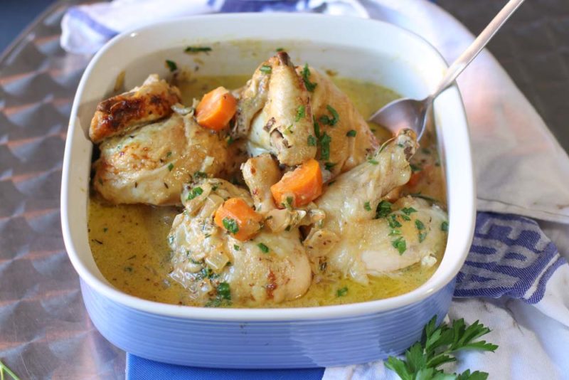 Chicken pieces cooked in orange and dijon creamy sauce in a blue dish
