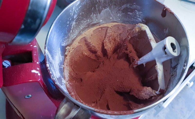 Chcoclate buttercream being mixed in a bowl