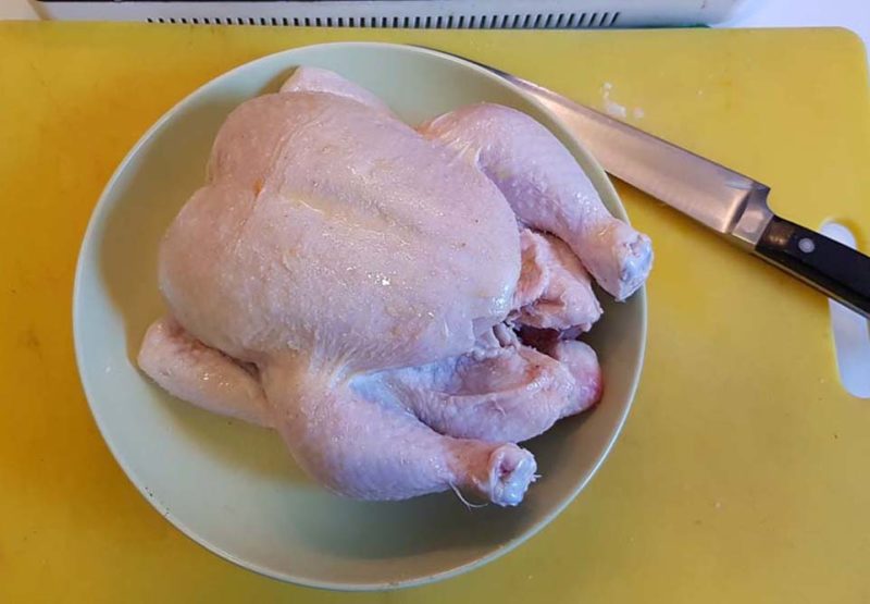 A 1.2 kg chicken painted with olive oil and salt