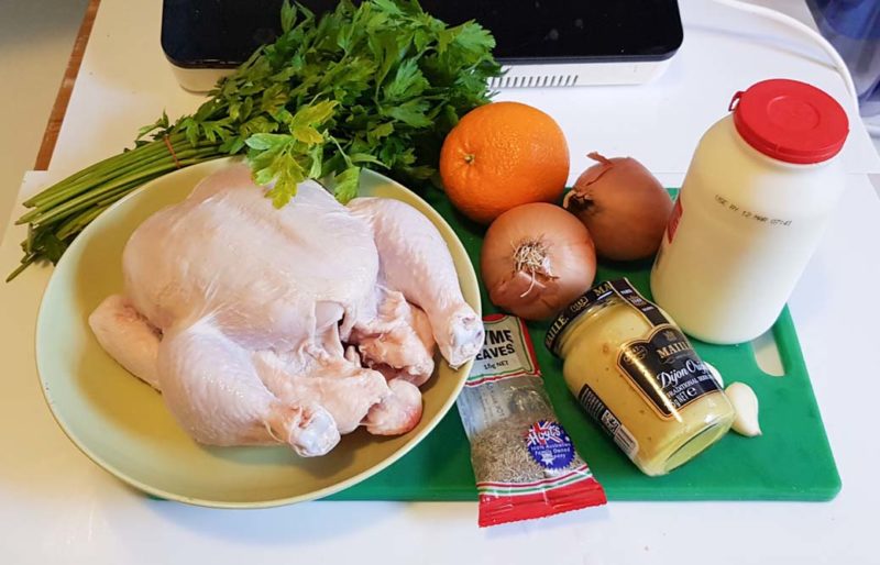 A selection of ingredients to make baked chicken with orange