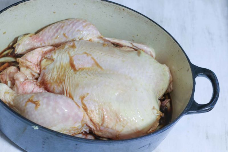 A chicken in a pot ready for baking