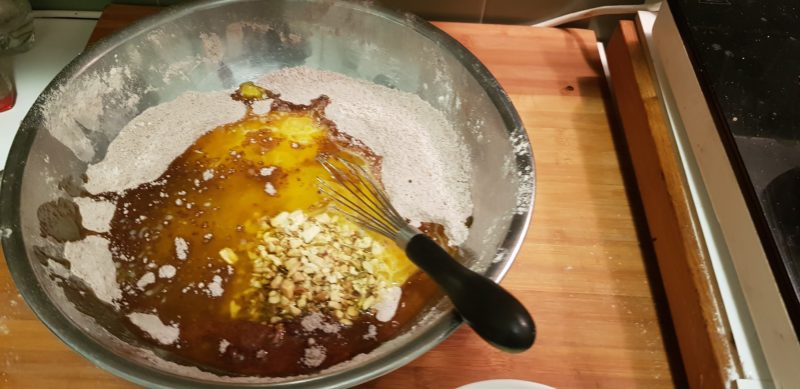 A bowl with the ingredients for cookies featuring melted butter