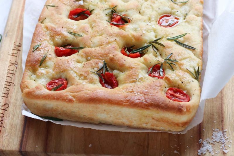 A slab of tomato and rosemary focaccia bread
